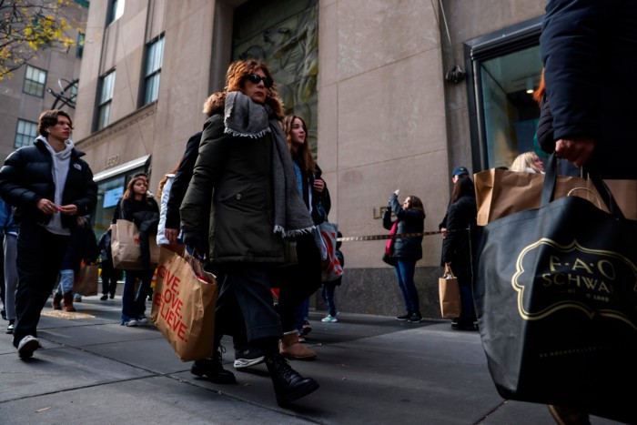 Shoppers carry bags down Fifth Avenue in New York, US on November 25 2022