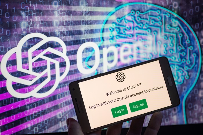 OpenAI logo seen on screen with ChatGPT website