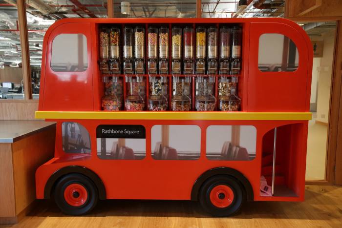 Candy dispenser decorated as a double-decker bus in Meta’s central London office